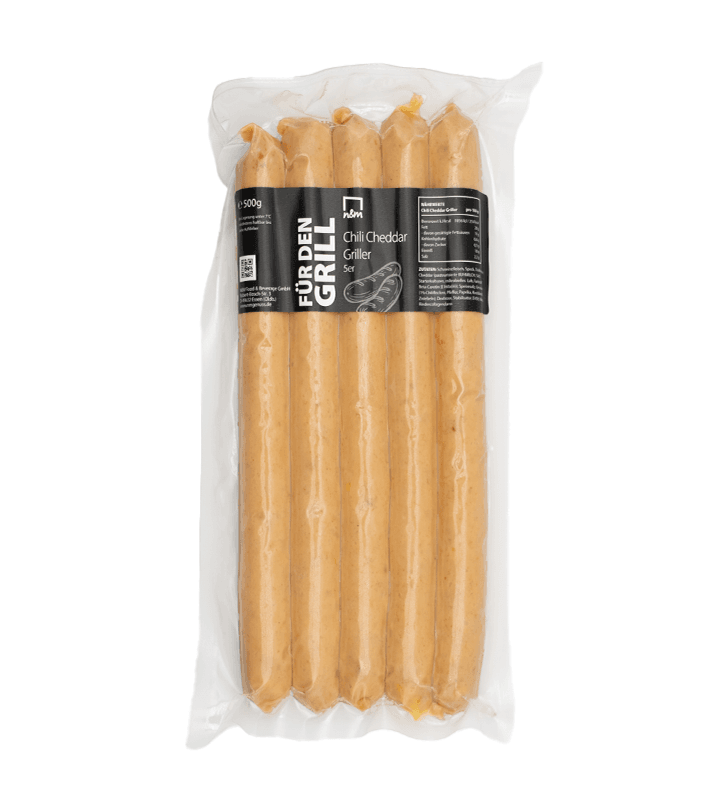 Vier lange Chili-Cheddar-Griller in einer transparenten Verpackung, mit schwarzem Etikett und weißer Beschriftung.